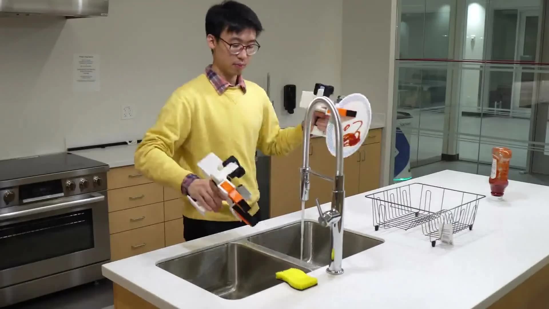 UMI researcher recording a kitchen task with handheld camera grippers